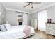 Cozy bedroom with hardwood floors, a white bed, and a sliding door to a bathroom at 1105 S Point Rd, Belmont, NC 28012