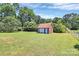 Outbuilding/garage on a grassy lot featuring a brick exterior and a fenced perimeter at 1105 S Point Rd, Belmont, NC 28012