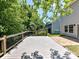 Well-maintained backyard features a wooden deck, tiled patio, and mature trees, ideal for outdoor living at 1124 Hunter St, Statesville, NC 28677