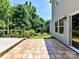 Expansive backyard with tiled patio, wooden deck, and lush greenery, perfect for outdoor entertaining and relaxation at 1124 Hunter St, Statesville, NC 28677