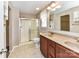 Bathroom with dual sinks, cherry cabinets, and glass shower at 1124 Hunter St, Statesville, NC 28677