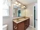 Bathroom featuring double sink vanity with granite countertop and brown cabinets at 1124 Hunter St, Statesville, NC 28677