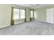 Bright bedroom featuring two windows with green curtains and plush carpet at 1124 Hunter St, Statesville, NC 28677