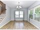 Bright dining area featuring large windows, modern chandelier, and neutral decor at 1124 Hunter St, Statesville, NC 28677