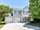 Charming two-story home with a two-car garage and a well-maintained front yard under a clear blue sky at 1124 Hunter St, Statesville, NC 28677