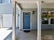 Inviting front porch with craftsman columns and decorative hanging plants leading to a blue front door at 1124 Hunter St, Statesville, NC 28677