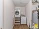 Functional laundry room featuring a washer, dryer, and storage shelves at 1124 Hunter St, Statesville, NC 28677