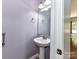 Classic powder room featuring a pedestal sink, a stylish mirror, and updated fixtures at 1124 Hunter St, Statesville, NC 28677