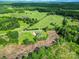 Wide aerial view showcasing the house and property surrounded by lush greenery and open spaces at 1166 Rocky River Rd, Lancaster, SC 29720