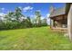 Large backyard with covered patio and stone fireplace at 1166 Rocky River Rd, Lancaster, SC 29720