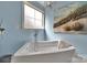 Bathroom featuring white stand alone tub and ocean scene artwork at 1166 Rocky River Rd, Lancaster, SC 29720