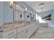 Bathroom featuring double sink with marble countertops, elegant mirrors and chandelier, and stand alone tub at 1166 Rocky River Rd, Lancaster, SC 29720