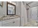 Bathroom view showcasing a granite countertop vanity, large mirror, a shower with a curtain, and tiled floors and shower walls at 1166 Rocky River Rd, Lancaster, SC 29720