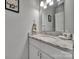 Nicely appointed half bathroom with a granite countertop and a decorative mirror at 1166 Rocky River Rd, Lancaster, SC 29720