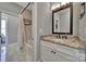 Bright bathroom featuring a granite countertop vanity, large mirror, and a shower with a shower curtain and tiled wall design at 1166 Rocky River Rd, Lancaster, SC 29720