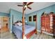 Cozy bedroom featuring hardwood floors, four-poster bed, and blue accent walls at 1166 Rocky River Rd, Lancaster, SC 29720