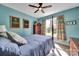 Bright bedroom featuring a four-poster bed, wood floors, and a sunny window view at 1166 Rocky River Rd, Lancaster, SC 29720