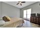 Bright bedroom with a large window, bed, dresser with television, ceiling fan and wood-look flooring at 1166 Rocky River Rd, Lancaster, SC 29720