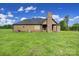 Back exterior of home with large yard at 1166 Rocky River Rd, Lancaster, SC 29720