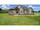 Charming stone and siding home with a covered front porch and well-manicured lawn at 1166 Rocky River Rd, Lancaster, SC 29720