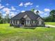 Beautiful exterior view of a home with stone accents and lush green lawn at 1166 Rocky River Rd, Lancaster, SC 29720