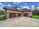 Spacious three-car garage with wooden doors and ample driveway space at 1166 Rocky River Rd, Lancaster, SC 29720