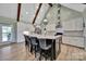 Spacious kitchen with granite counters, island with seating, stainless appliances, and wooden beams at 1166 Rocky River Rd, Lancaster, SC 29720