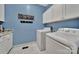 Functional laundry room with white cabinets, modern appliances, and a utility sink at 1166 Rocky River Rd, Lancaster, SC 29720