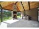 Covered outdoor patio offers a stone fireplace and outdoor kitchen at 1166 Rocky River Rd, Lancaster, SC 29720