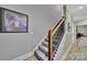 Carpeted staircase with wood and iron railing, leading to the upper level of the home at 1166 Rocky River Rd, Lancaster, SC 29720
