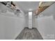 Walk-in closet features built-in shelving and carpeted floors for efficient storage at 1166 Rocky River Rd, Lancaster, SC 29720