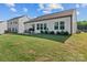 Spacious backyard featuring a patio, green lawn, well-maintained landscaping, and white fence at 122 Dyssa Loop, Statesville, NC 28625