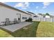 Backyard with a concrete patio, grill, lawn, a view of neighboring houses, and white fence at 122 Dyssa Loop, Statesville, NC 28625