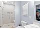 Tiled shower with glass door, bright vanity and sink, and modern fixtures at 122 Dyssa Loop, Statesville, NC 28625