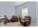 Bedroom with recliners, and a side table, with ample natural light at 122 Dyssa Loop, Statesville, NC 28625