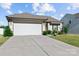 Well-maintained home with a two-car garage and a spacious driveway and landscaped yard at 122 Dyssa Loop, Statesville, NC 28625
