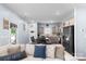 Open-concept kitchen and dining area with gray cabinets and stylish modern black appliances at 122 Dyssa Loop, Statesville, NC 28625
