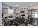 Eat-in kitchen featuring granite countertops, stainless steel appliances and light gray cabinetry at 122 Dyssa Loop, Statesville, NC 28625