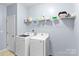 Well-equipped laundry room with modern, white Samsung appliances and ample shelving for storage at 122 Dyssa Loop, Statesville, NC 28625