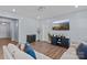 Modern living room featuring wood floors, a large TV, and comfortable neutral colored seating at 122 Dyssa Loop, Statesville, NC 28625