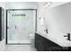 Elegant bathroom with a glass-enclosed shower, marble walls, and dual vanities with modern fixtures at 12305 Gambrell Dr, Charlotte, NC 28278
