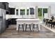Modern kitchen featuring a spacious island with seating, stainless steel appliances, and stylish dark cabinetry at 12305 Gambrell Dr, Charlotte, NC 28278