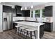 Modern kitchen with black cabinets, stainless steel appliances, and a central island with bar seating at 12305 Gambrell Dr, Charlotte, NC 28278