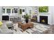 Open-concept living room with modern furnishings, a fireplace, and a spacious kitchen island at 12305 Gambrell Dr, Charlotte, NC 28278