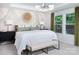 Bright main bedroom with wallpaper design, pendant lighting, bench, and large windows at 12305 Gambrell Dr, Charlotte, NC 28278
