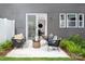Inviting outdoor patio with modern seating, lush landscaping, and sliding glass doors for indoor-outdoor living at 12305 Gambrell Dr, Charlotte, NC 28278