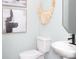 Stylish powder room featuring a pedestal sink, modern fixtures, and artistic decor at 12305 Gambrell Dr, Charlotte, NC 28278