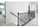 Carpeted staircase with wood and metal railings, leading to the upper level at 12305 Gambrell Dr, Charlotte, NC 28278