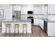 Stylish kitchen featuring white cabinets, granite counters, stainless steel appliances and breakfast bar at 12309 Gambrell Dr, Charlotte, NC 28278