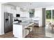 Modern kitchen with stainless steel appliances, white cabinetry, granite countertops, and breakfast bar at 12309 Gambrell Dr, Charlotte, NC 28278